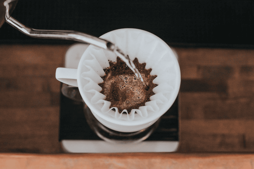 Brewing coffee in a white mug.